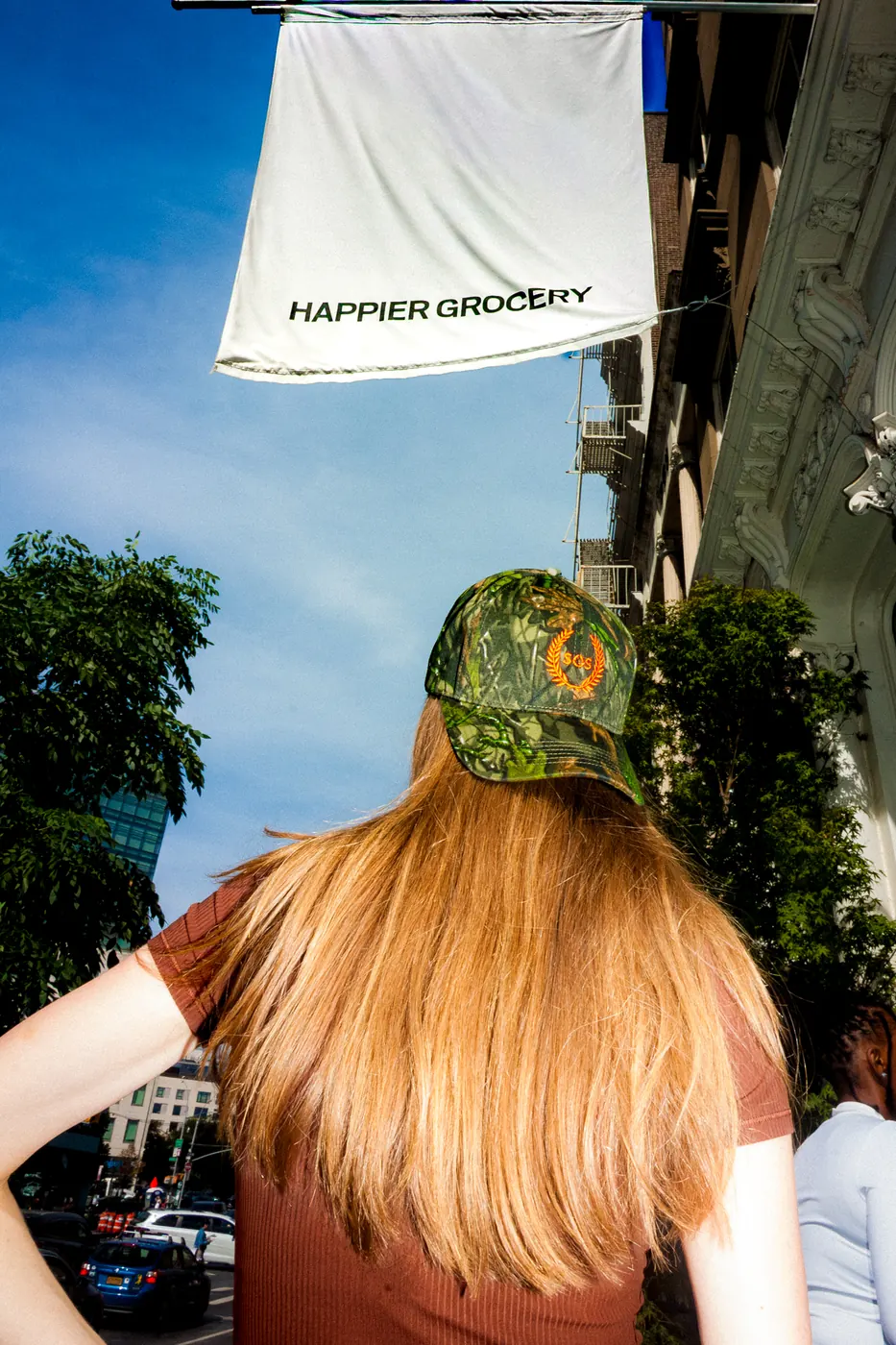 Club hat outside Happier Grocery